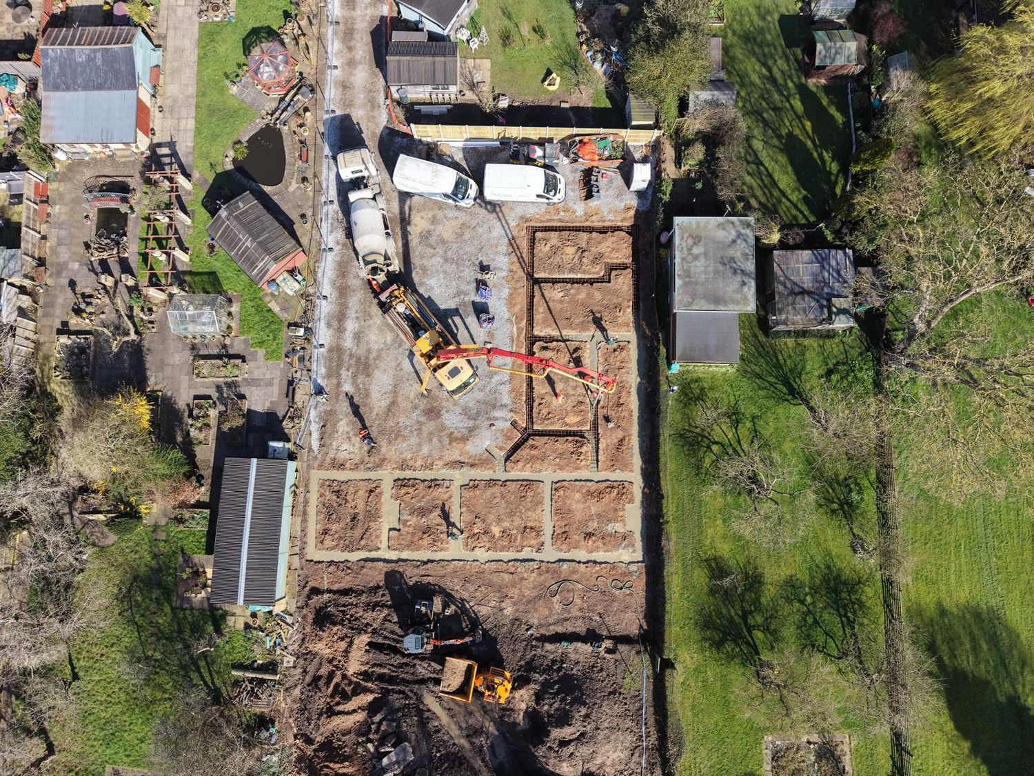 Aerial view with concrete being pumped into the foundations