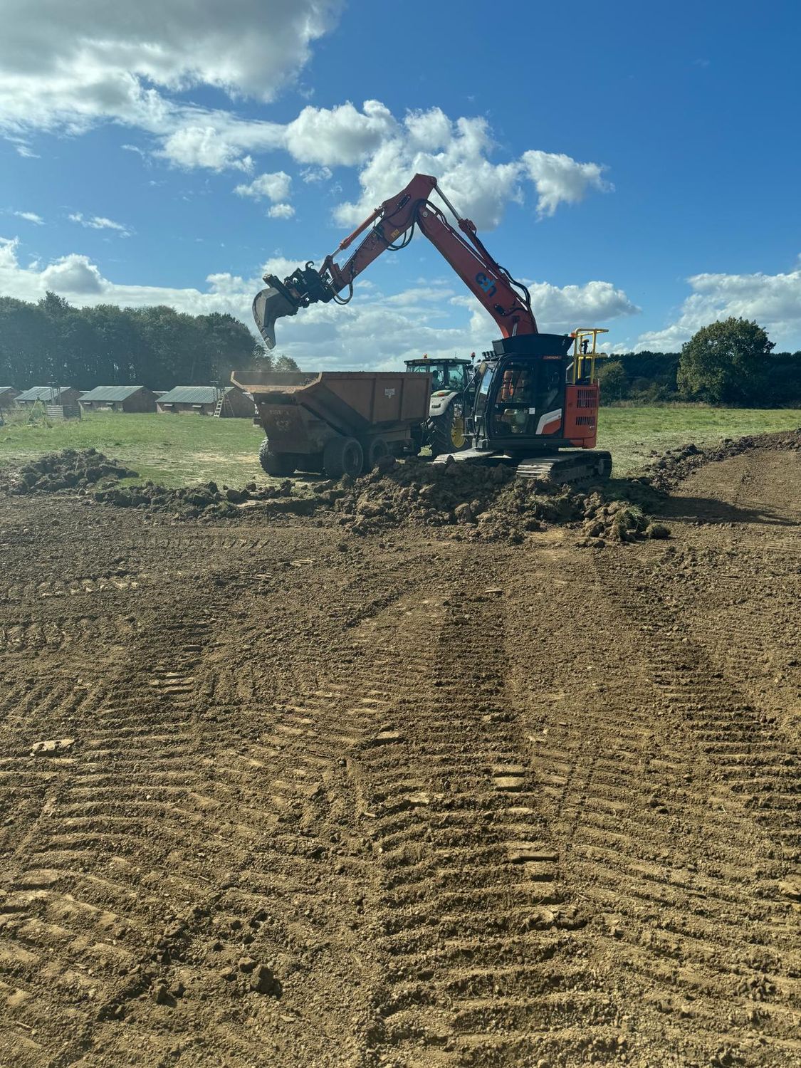 Excavator loading a dumper during enabling works