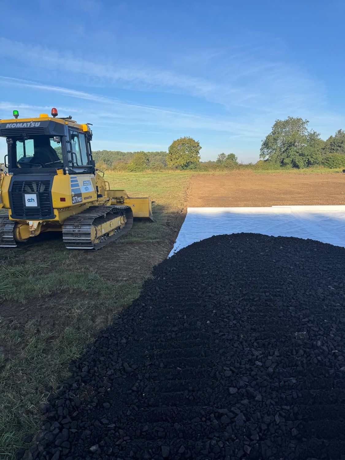 Dozer placing stone over a geotextile