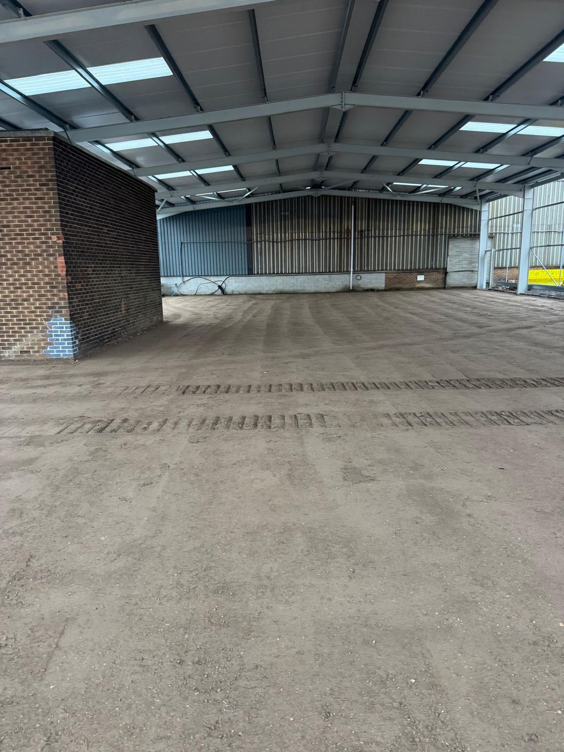 Floor sub-base graded inside a portal frame building