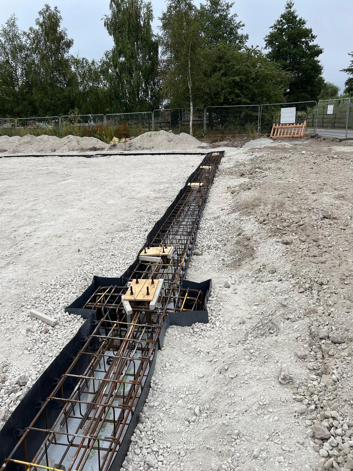 Ground beam reinforcement cage in formwork over the piles