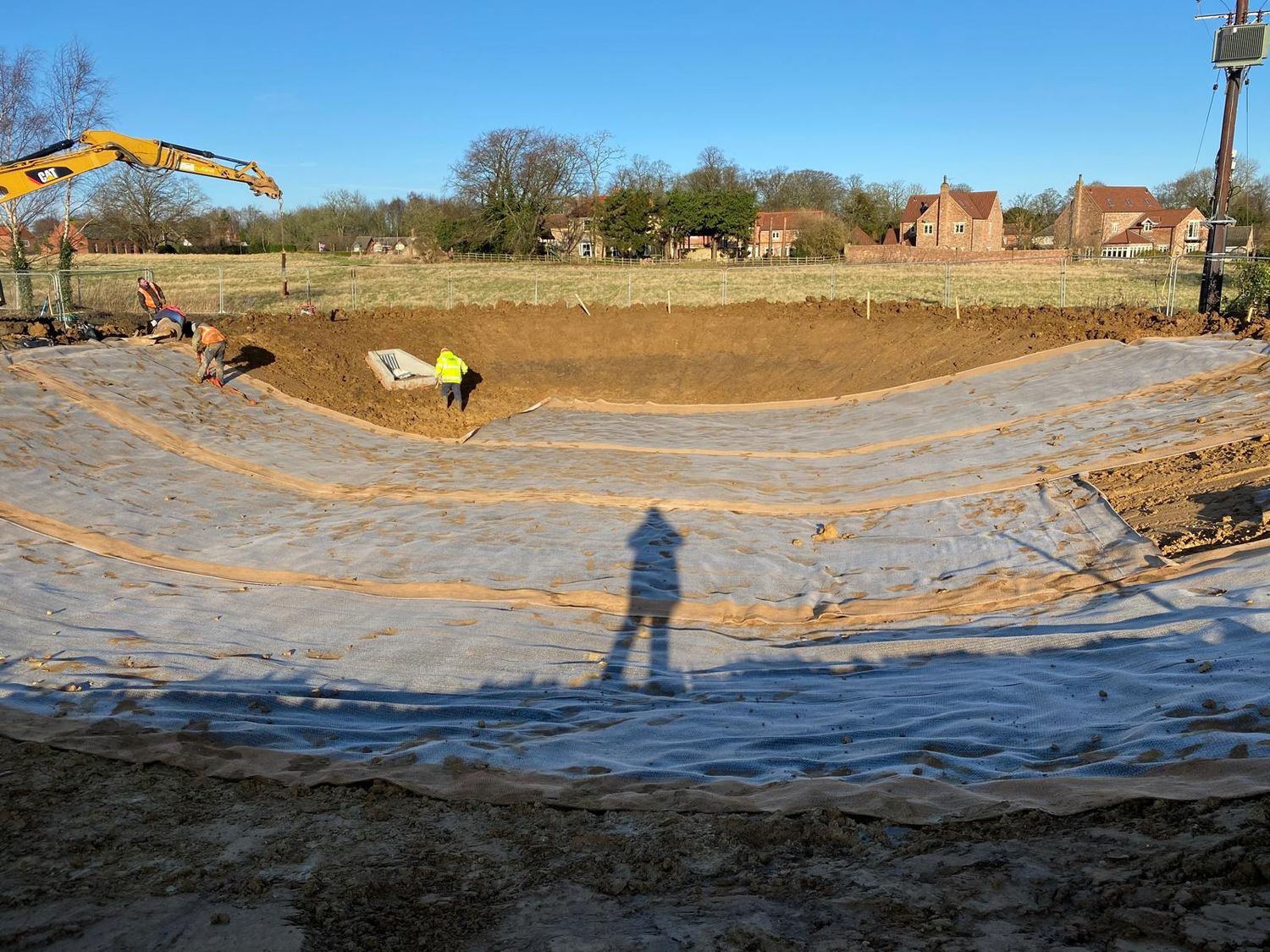 Pond excavation lined with geotextile