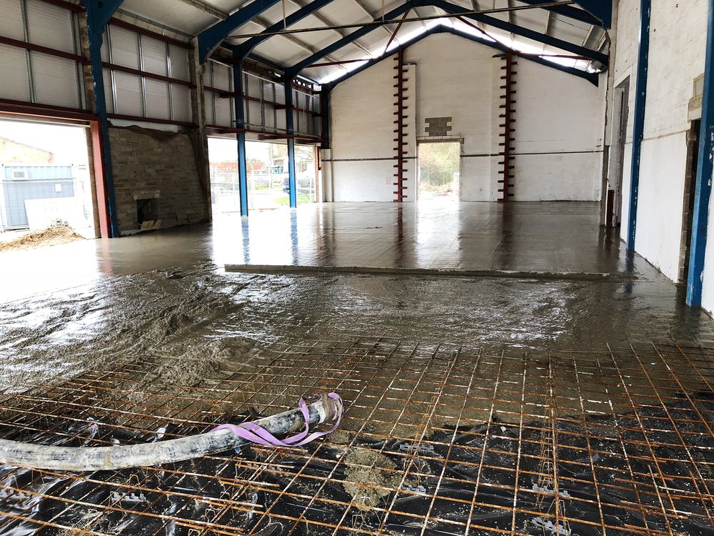 Reinforcement mesh and fresh concrete inside a warehouse